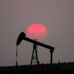 FILE PHOTO: The sun sets behind a pump-jack outside Saint-Fiacre