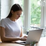 Millennial woman work online on laptop at home